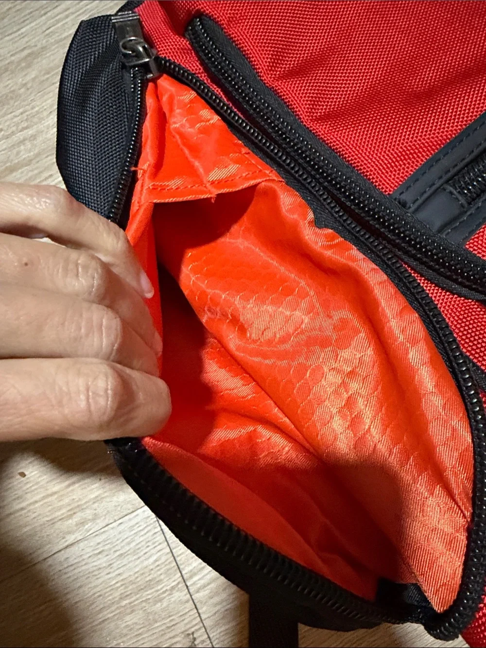 Tumi Red and Black Men/Women’s Backpack with Multiple Front Pockets